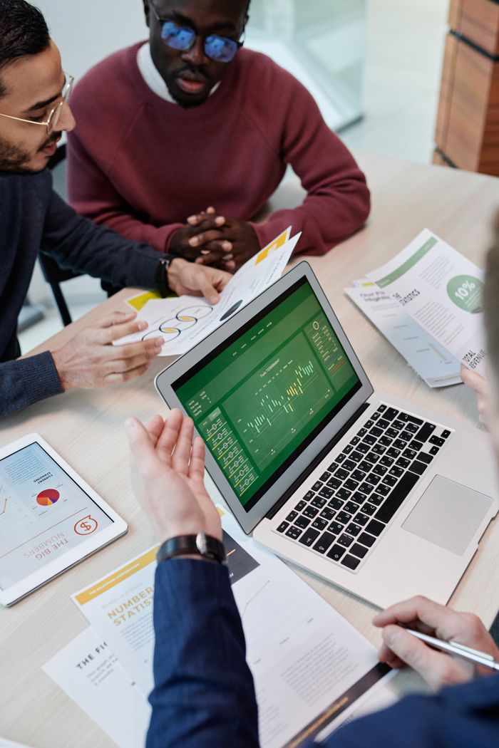 Mastering the First Impression: Your intriguing post title goes here A multicultural team engaged in a collaborative meeting with a laptop and documents in a modern office setting.